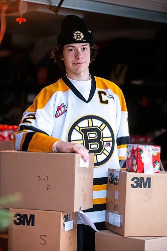 MIKAELA MACKENZIE / WINNIPEG FREE PRESS
	
Tyden Lafournaise with Christmas Cheer Board hampers ready to be delivered by him and his Winnipeg Bruins teammates this weekend on Friday, Dec. 8, 2023.
Winnipeg Free Press 2023