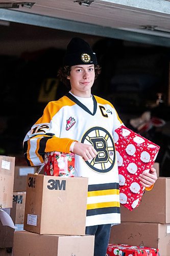 MIKAELA MACKENZIE / WINNIPEG FREE PRESS
	
Tyden Lafournaise with Christmas Cheer Board hampers ready to be delivered by him and his Winnipeg Bruins teammates this weekend on Friday, Dec. 8, 2023.
Winnipeg Free Press 2023