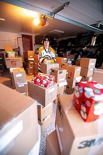 MIKAELA MACKENZIE / WINNIPEG FREE PRESS
	
Tyden Lafournaise with Christmas Cheer Board hampers ready to be delivered by him and his Winnipeg Bruins teammates this weekend on Friday, Dec. 8, 2023.
Winnipeg Free Press 2023