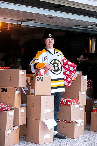 MIKAELA MACKENZIE / WINNIPEG FREE PRESS
	
Tyden Lafournaise with Christmas Cheer Board hampers ready to be delivered by him and his Winnipeg Bruins teammates this weekend on Friday, Dec. 8, 2023.
Winnipeg Free Press 2023