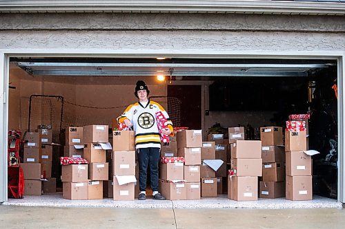 MIKAELA MACKENZIE / WINNIPEG FREE PRESS
	
Tyden Lafournaise with Christmas Cheer Board hampers ready to be delivered by him and his Winnipeg Bruins teammates this weekend on Friday, Dec. 8, 2023.
Winnipeg Free Press 2023