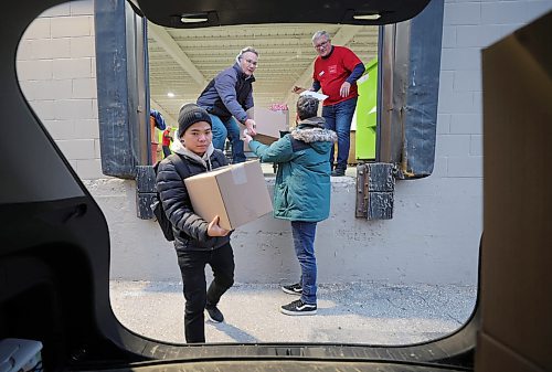 RUTH BONNEVILLE / WINNIPEG FREE PRESS

Local - First Delivery of Christmas Cheer hampers

 Yuri Spirkin (grey jacket on platform), Christian Atupan (black jacket)  and Max Ewaschuk (green jacket),  load up Christmas hampers into one of their vehicles to deliver them to those in need Friday.  The trio from Wawanesa group were the first delivery crew of the year with hundreds of crews to follow in the coming days and weeks. 

Dec 8th,  2023