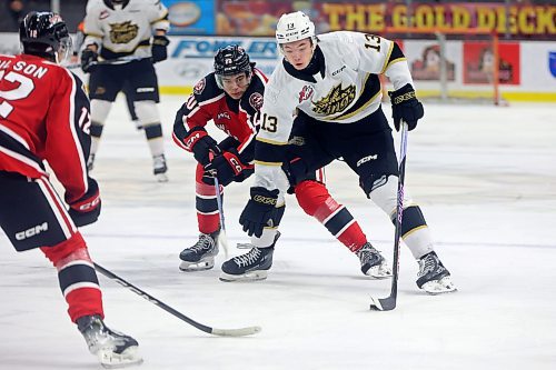 08122023
Roger McQueen #13 of the Brandon Wheat Kings plays the puck in front of Pavel McKenzie #20 of the Moose Jaw Warriors during WHL action at Westoba Place on Friday evening.
(Tim Smith/The Brandon Sun)