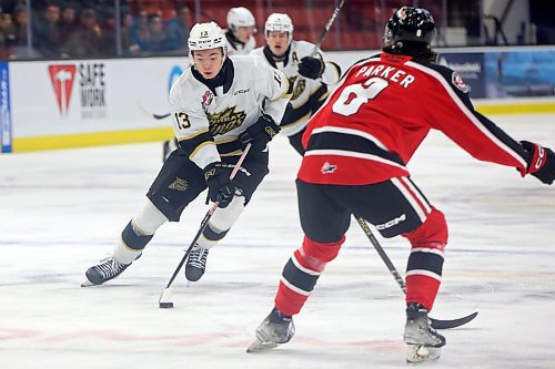 08122023
Roger McQueen #13 of the Brandon Wheat Kings tries to move the puck past Kalem Parker #8 of the Moose Jaw Warriors during WHL action at Westoba Place on Friday evening.
(Tim Smith/The Brandon Sun)