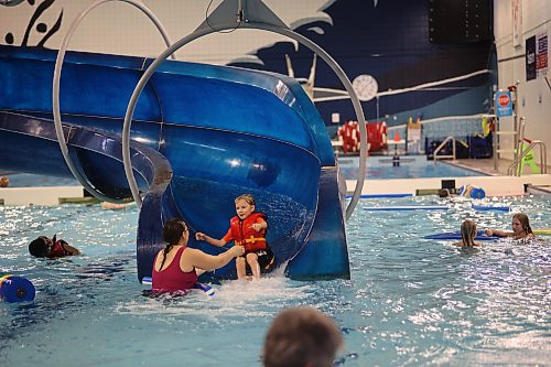 Left to Right: Hedy Higgins reaches out to her son, Cody, 6, as he comes out of the Water Slide on Saturday afternoon during the Jolly Holiday Swin at the Sportsplex pool. Photos: Abiola Odutola/The Brandon Sun