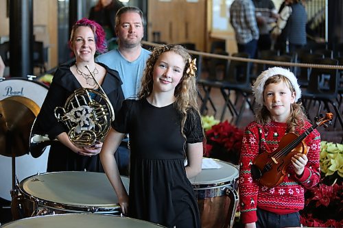 BELOW: Percussionist Lydia Purdy, 13, stands next to her 10-year-old brother Gabe, violinist, while her mom Jenn, holding her French horn, and dad Mike stand behind. (Michele McDougall/The Brandon Sun) 
