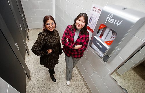 JOHN WOODS / WINNIPEG FREE PRESS
University of Winnipeg Student Association (UWSA) president Tomiris Kaliyeva, right, and Christine Quiah, VP of student affairs, are photographed with one of their menstrual pad, tampon and other menstrual product dispensers in a bathroom on campus Monday, December 11, 2023. The University of Winnipeg is the latest campus making pads, tampons and other menstrual products free of charge to students, staff and passersby.

Reporter: maggie
