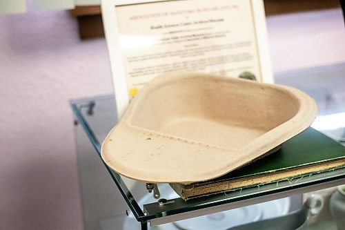 MIKAELA MACKENZIE / WINNIPEG FREE PRESS
	
A modern cardboard bedpan at the Health Science&#x573; Centre archives on Monday, Dec. 11, 2023. Students at Brandon University took the bedpans on as research projects. For Dave Sanderson story.
Winnipeg Free Press 2023