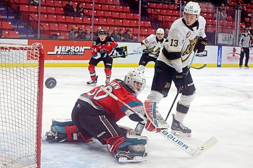 13122023
Roger McQueen #13 of the Brandon Wheat Kings watches as netminder Jari Kykkanen #31 of the Kelowna Rockets deflects a shot on net during WHL action at Westoba Place on Wednesday evening.   (Tim Smith/The Brandon Sun)