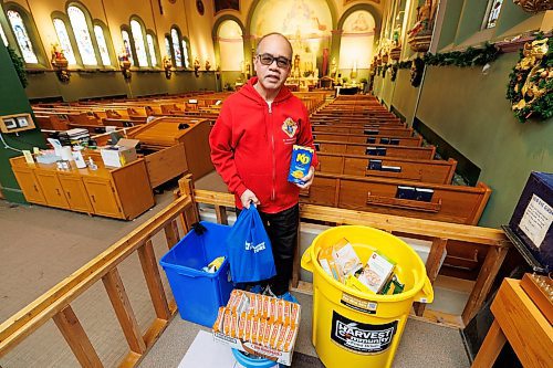 MIKE DEAL / WINNIPEG FREE PRESS
Johnny Ortizo holds some of the donated food in the St. Edward the Confessor Church at 836 Arlington Street. Ortizo is organizing a food drive for Harvest Manitoba and is a member of Knights of Columbus St. Edward Council. The food drive is happening from Dec. 1 to Jan. 31.
See Matthew Frank story 
231214 - Thursday, December 14, 2023.