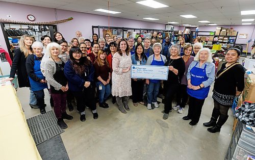 MIKE DEAL / WINNIPEG FREE PRESS
A large number of staff and volunteers gather with cheque holders, Lea Pawloski (left), Chief Operating Officer, and Karin Brewer (right), Board Chair.
Kildonan MCC Thrift Shop is celebrating. The store has raised a record $1,000,000 for MCC MB, the largest donation the store has ever made in its history.
See Janine LeGal story
231214 - Thursday, December 14, 2023.