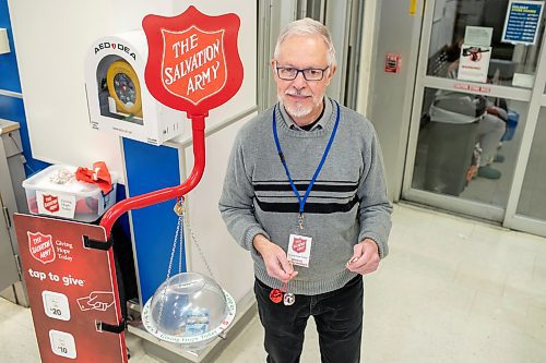 BROOK JONES / WINNIPEG FREE PRESS
John Longhurst, who has been the Winnipeg Free Press faith columnist/reporter since 2003, holds Christmas bells and a candy cane as he volunteers for the Salvation Army's Christmas Kettle campaign by helping to collecting donations at the Superstore at Gateway Road and McLeod Avenue in Winnipeg, Man., Thursday, Dec. 14, 2023. The Salvation Army's Christmas Kettle campaign is one of Canada's largest and most recognizable annual charitable events with 2,000 locations across Canada.
