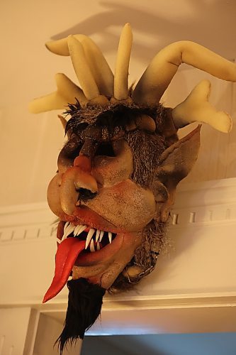 A Krampus mask hangs on Marilyn Hardy's wall in her house. She made three of the masks and full costumes for herslef and friends for fun. (Kyla Henderson/The Brandon Sun)