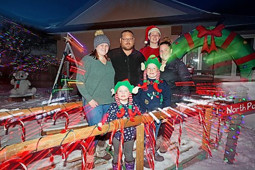 18122023
Jeff and Tara Carey (back centre and back right respectively) and their four children Morgan (L) Kinslee (front left) Chase (front right) and Emerson (santa hat) outside their brightly decorated home along the 2700 block of Princess Avenue on Monday evening.
(Tim Smith/The Brandon Sun)