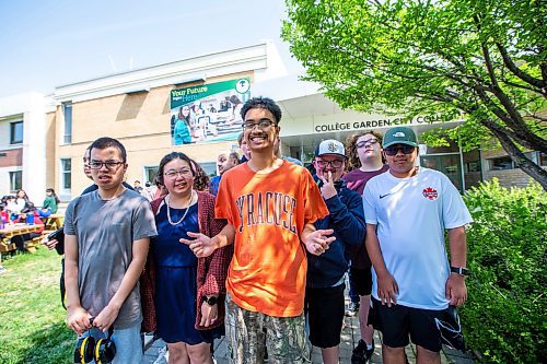 MIKAELA MACKENZIE / WINNIPEG FREE PRESS
 
Orion Remoquillo, a grade 12 student who volunteers with students with special needs (centre, orange shirt), poses for a photo with some of the students he volunteers with at Garden City Collegiate on Thursday, May 25, 2023. Orion was recently recognized with one of 15 Terry Fox Humanitarian Awards. For Aaron Epp story.

Winnipeg Free Press 2023.