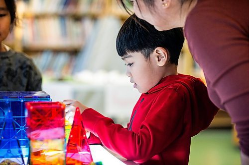 MIKAELA MACKENZIE / WINNIPEG FREE PRESS
	
Marites Lacson and her son, Jared Lacson (seven), take part in the Young Designer Program at Weston School on Wednesday, Dec. 13, 2023. For Maggie story.
Winnipeg Free Press 2023