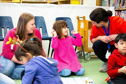 MIKAELA MACKENZIE / WINNIPEG FREE PRESS
	
Geneveive Lavallee (four) raises her arms after a successful robot run as her mom, Madison Harcus (left), and program lead Adam Charbonneau help at the Young Designer Program at Weston School on Wednesday, Dec. 13, 2023. For Maggie story.
Winnipeg Free Press 2023