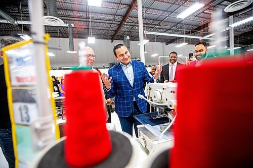 MIKAELA MACKENZIE / WINNIPEG FREE PRESS
	
Wab Kinew tries his hand at sewing a patch during a tour of the Canada Goose factory on Friday, Dec. 15, 2023. For Maggie story.
Winnipeg Free Press 2023