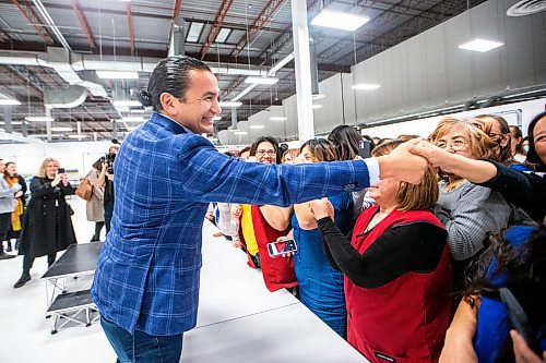 MIKAELA MACKENZIE / WINNIPEG FREE PRESS
	
Wab Kinew greets excited employees during a tour of the Canada Goose factory on Friday, Dec. 15, 2023. For Maggie story.
Winnipeg Free Press 2023