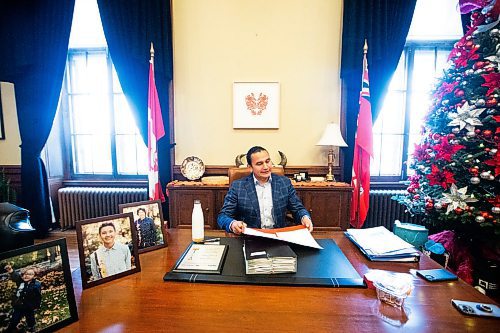 MIKAELA MACKENZIE / WINNIPEG FREE PRESS
	
Wab Kinew looks through a fresh batch of urgent papers in his office on Friday, Dec. 15, 2023. For Maggie story.
Winnipeg Free Press 2023