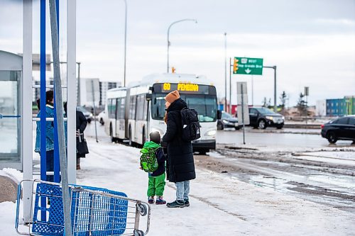 MIKAELA MACKENZIE / WINNIPEG FREE PRESS
	
Venera Sorkina and her son, Ivan, wait for the second bus on their way back home from Mosaic's English language class on Monday, Dec. 11, 2023. At this bus stop in the past they have had to go and warm up in a nearby McDonald&#x573; when multiple buses have been late or cancelled. For Malak story.
Winnipeg Free Press 2023