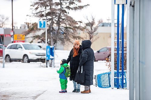 MIKAELA MACKENZIE / WINNIPEG FREE PRESS
	
Venera Sorkina and her son, Ivan, greet a fellow regular as they wait for the second bus on their way back home from Mosaic's English language class on Monday, Dec. 11, 2023. Venera enjoys the social aspect of public transit, and the opportunity to practice her English. For Malak story.
Winnipeg Free Press 2023