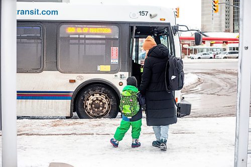 MIKAELA MACKENZIE / WINNIPEG FREE PRESS
	
Venera Sorkina and her son, Ivan, wait for the second bus on their way back home from Mosaic's English language class on Monday, Dec. 11, 2023. At this bus stop in the past they have had to go and warm up in a nearby McDonald&#x573; when multiple buses have been late or cancelled. For Malak story.
Winnipeg Free Press 2023