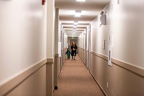 MIKAELA MACKENZIE / WINNIPEG FREE PRESS
	
Venera Sorkina and her son, Ivan, walk down the hallway to their apartment after taking the bus back home from Mosaic's English language class on Monday, Dec. 11, 2023. For Malak story.
Winnipeg Free Press 2023