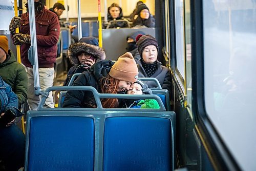 MIKAELA MACKENZIE / WINNIPEG FREE PRESS
	
Venera Sorkina and her son, Ivan, take the second bus on their way back home from Mosaic's English language class on Monday, Dec. 11, 2023. For Malak story.
Winnipeg Free Press 2023
