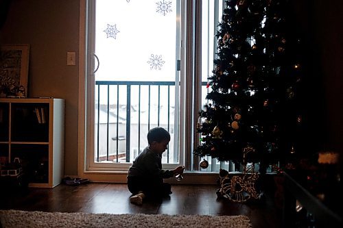MIKAELA MACKENZIE / WINNIPEG FREE PRESS
	
Ivan Sorkina plays with the Christmas tree after taking the bus back home from daycare and his mom&#x573; Mosaic's English language class on Monday, Dec. 11, 2023. For Malak story.
Winnipeg Free Press 2023
