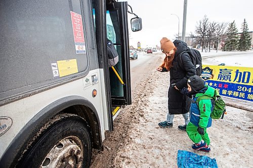 MIKAELA MACKENZIE / WINNIPEG FREE PRESS
	
Venera Sorkina and her son, Ivan, board the first bus back home from Mosaic's English language class on Monday, Dec. 11, 2023. For Malak story.
Winnipeg Free Press 2023