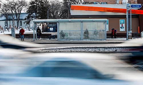 JOHN WOODS / WINNIPEG FREE PRESS
People wait for the bus at the stop on Portage Avenue across from Polo Park in Winnipeg Tuesday, December 19, 2023. 

Reporter: ?