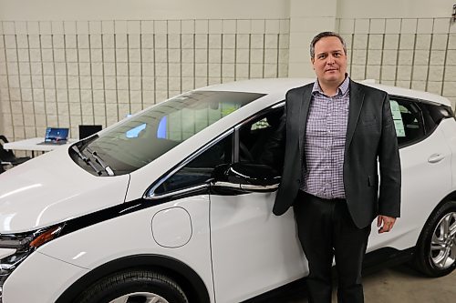 Murray Chevrolet Cadillac Buick GMC Brandon dealer principal Rich Pentney with a 2023 Chevrolet Bolt EV LT. Pentney says Brandon is in critical need of improved infrastructure, saying the challenge of insufficient charging stations is a significant barrier to widespread EV adoption. Photo: Abiola Odutola/The Brandon Sun