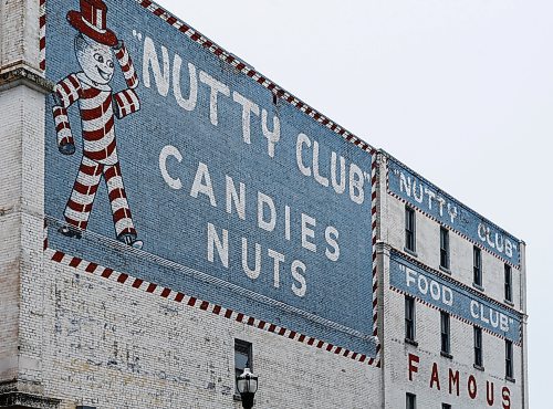 The Scott-Bathgate Nutty Club building on Lombard, adorned by the image of the candy company's mascot, Can-D-Man, photographed on Sunday. A changing candy market has forced the famous Winnipeg Nutty Club brand to cease operation. (John Woods/Winnipeg Free Press)