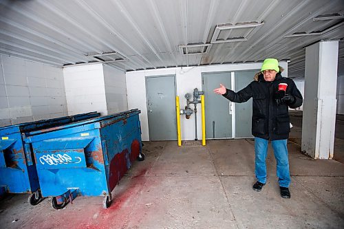 MIKAELA MACKENZIE / WINNIPEG FREE PRESS
	
Arthur Szymkow, who lives across the alley from the scene, shows the dumpsters that the police investigated at 24 Carlton Street on Wednesday, Dec. 20, 2023. For Erik story.
Winnipeg Free Press 2023