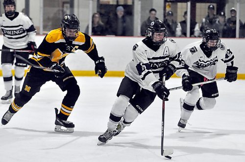 The top scorer in the Westman High School Hockey League is Josh Romanik (16), shown moving the puck along with linemate Brady Wiltsey (2) while being chased by Neepawa Tigers captain Tarek Lapointe, who leads his team with 17 goals and 31 points. He was held to an assist in his team's 5-3 to the Vincent Massey Vikings on Wednesday night. Romanik and Wiltsey each had a goal and as assist for the Vikings, who improved to 13-2-0 and moved into first place, on point up on the Dauphin Clippers. Romanik's point total improved to 16 goals and 48 points in 16 games. (Jules Xavier/The Brandon Sun)