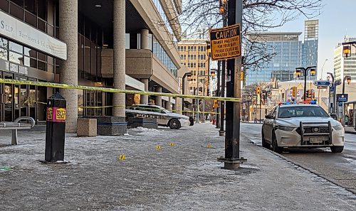 About a dozen yellow evidence markers were placed on the sidewalk in front of the Cargill Building. (Chris Kitching / Winnipeg Free Press)