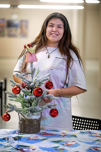 RUTH BONNEVILLE / WINNIPEG FREE PRESS

Local -  N'Dinawemak 

Feature pm  N'Dinawemak &#x2014; Our Relatives' Place at 190 Disraeli Freeway and some of their clients that have become volunteers at the centre.  

Portrait of Kyla Ouskun, who volunteers her time cleaning washrooms and helping out wherever she can at the centre,  

Photo taken upstairs, in the women's dormitory as she enjoys dressing a small, tabletop, Christmas tree decoration on their dining table in their dormitory Thursday. 
 
Feature by Niigaan 

Dec 21st,  2023