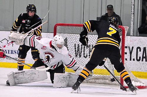 Wheat Kings forward Brady Turko (7) scores his league-best 22nd goal, the second of two in Brandon's 8-3 victory, on Pembina Valley Hawks goalie Ryler Gates. Teammate Easton Odut (16) looks on Thursday night during third-period action at J&G Homes Arena. (Photo Jules Xavier/The Brandon Sun)