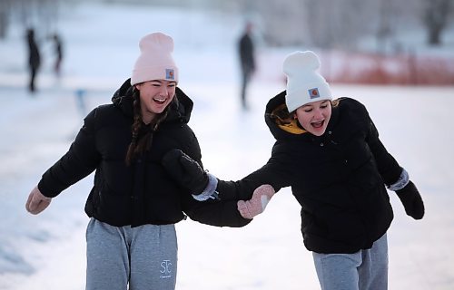 22122023
Friends Mya Lindenberg and Ella Vandaele laugh while skating at the skating oval on Friday. 
(Tim Smith/The Brandon Sun)