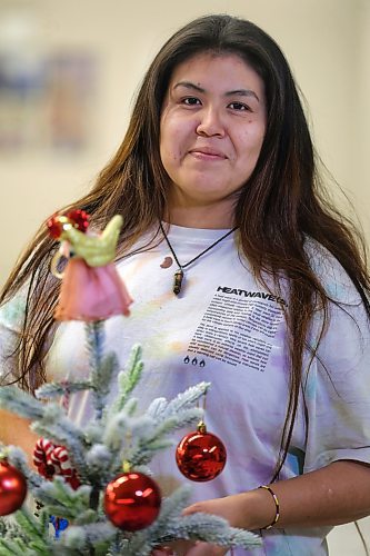 RUTH BONNEVILLE / WINNIPEG FREE PRESS

Local -  N'Dinawemak 

Feature pm  N'Dinawemak &#x2014; Our Relatives' Place at 190 Disraeli Freeway and some of their clients that have become volunteers at the centre.  

Portrait of Kyla Ouskun, who volunteers her time cleaning washrooms and helping out wherever she can at the centre,  

Photo taken upstairs, in the women's dormitory as she enjoys dressing a small, tabletop, Christmas tree decoration on their dining table in their dormitory Thursday. 
 
Feature by Niigaan 

Dec 21st,  2023