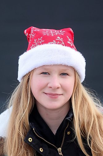 22122023
Lux Opperman wears a festive santa hat while walking to school with friends over the noon hour in Brandon on Friday.
(Tim Smith/The Brandon Sun)