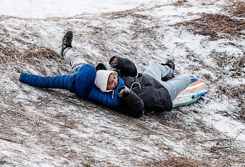 JOHN WOODS / WINNIPEG FREE PRESS
Friends Mavo, left, and Dustin wipeout as they slide down Garbage Hill at Westvew Park in Winnipeg Tuesday, December  26, 2023. 

Reporter: standup