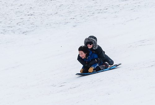 JOHN WOODS / WINNIPEG FREE PRESS
Brothers Eiji, front, and Akira Adaman slide down Garbage Hill at Westvew Park in Winnipeg Tuesday, December  26, 2023. 

Reporter: standup