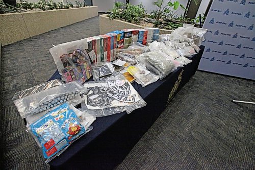 Illicit cannabis products, gang patches, cigarettes and other goods seized in a large RCMP drug investigation on March 14. ERIK PINDERA/WINNIPEG FREE PRESS