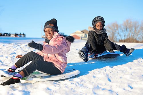 Ayanfe Omole, 6 (left), and Ayobamidele Odutola, 5, enjoy the winter slide at Hanbury Hill (1-19 Buffalo Way) on Wednesday. Hanbury Hill, a toboggan hill that all ages enjoy for some winter fun, provides a long enjoyable run for the older ages and a smaller run on the backside of the hill for the younger children. Photos: Abiola Odutola/The Brandon Sun. 