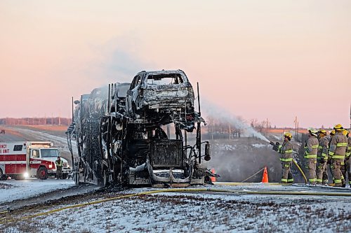 29122023
Firefighters extinguish a blaze after a semi-trailer carrying cars caught fire in the westbound lanes of the Trans-Canada Highway east of Carberry on Friday afternoon. 
(Tim Smith/The Brandon Sun)