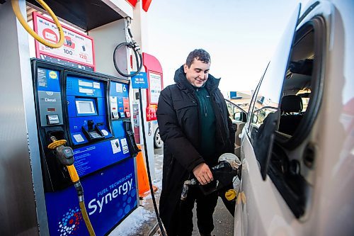 MIKAELA MACKENZIE / WINNIPEG FREE PRESS
	
Egor (no last name given) fills up his tank at the Polo Park Mobil gas station on Friday, Dec. 29, 2023. The gas tax will be paused on Jan. 1st, which should further reduce gas prices. For Danielle story.
Winnipeg Free Press 2023