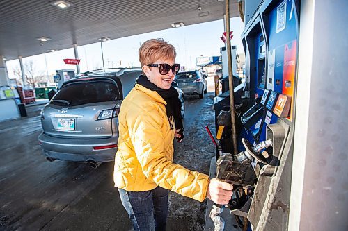 MIKAELA MACKENZIE / WINNIPEG FREE PRESS
	
Cynthia Dutton fills up her tank at the Polo Park Mobil gas station on Friday, Dec. 29, 2023. The gas tax will be paused on Jan. 1st, which should further reduce gas prices. For Danielle story.
Winnipeg Free Press 2023