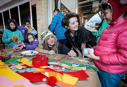 JOHN WOODS / WINNIPEG FREE PRESS
Sheena Rattai, Event Manager, left, and Victoria Hill, Marketing and Communications Manager, do crafts with children at New Year&#x2019;s Day festivities at The Forks in Winnipeg Monday, January 1, 2024. 

Reporter: nicole